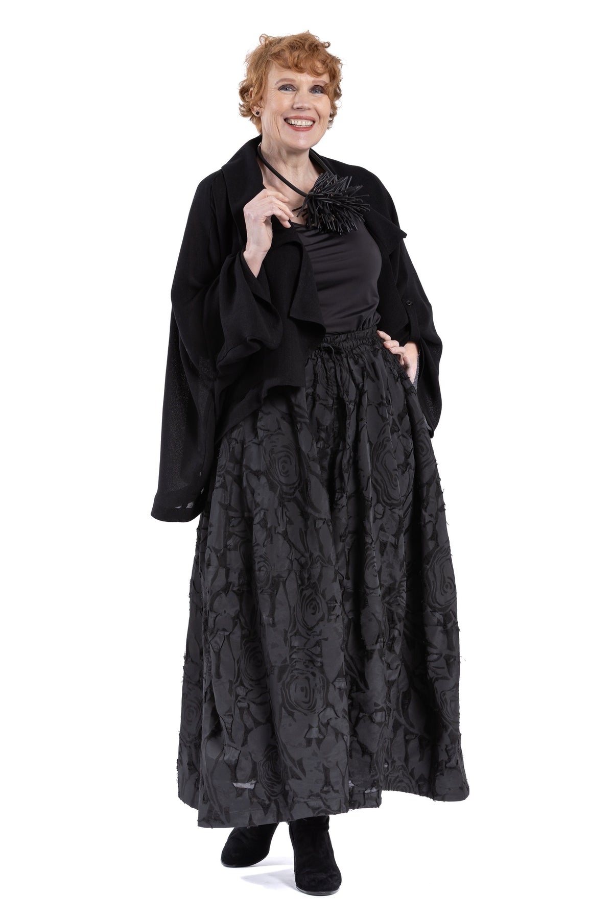 Black lapel jacket front view showing draped collar.