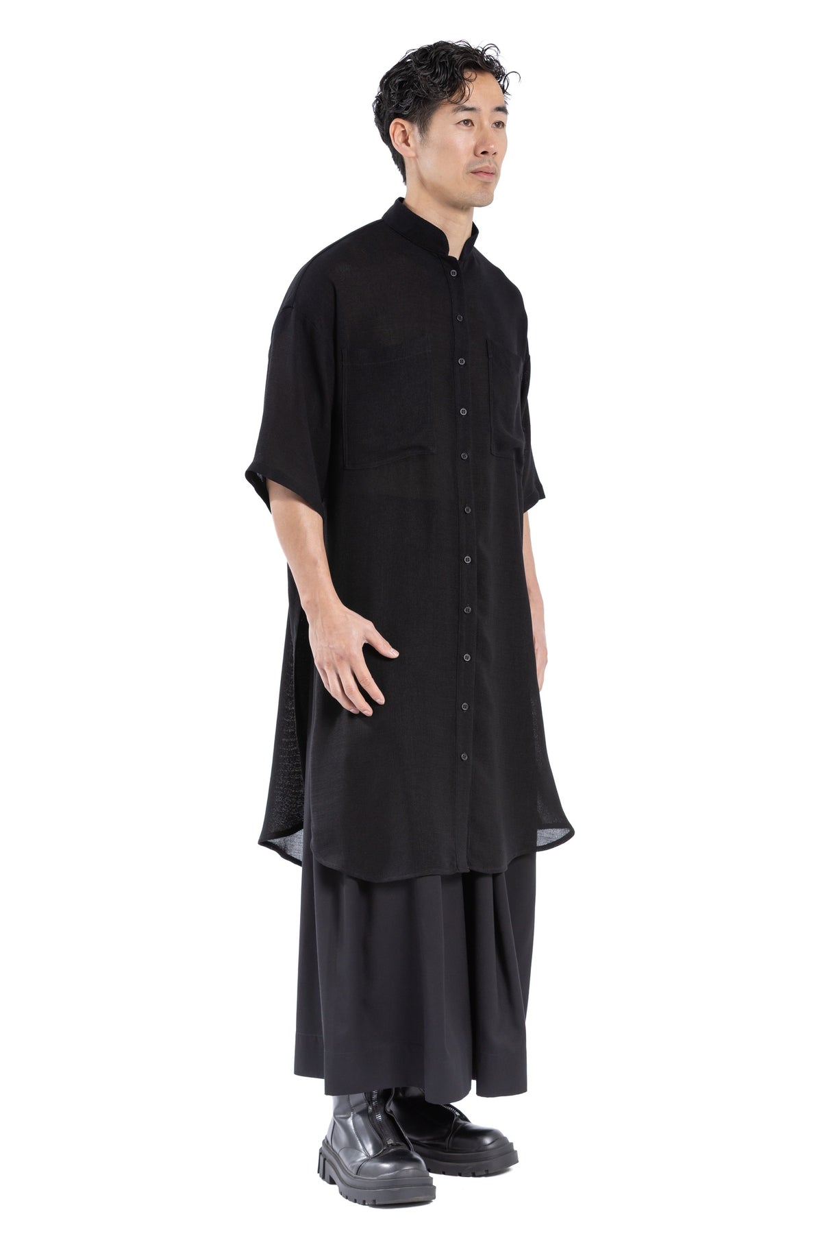 Fabric drape and hem detail of black shirt dress.