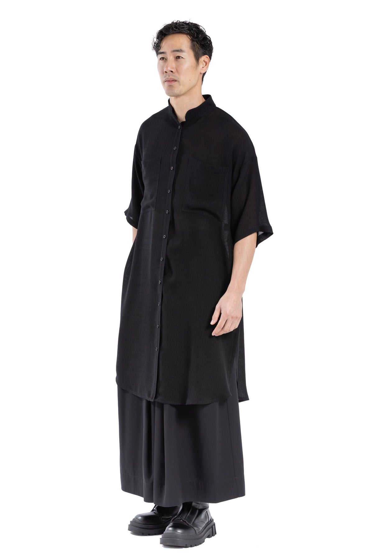 Detail of patch chest pockets on black shirt dress.